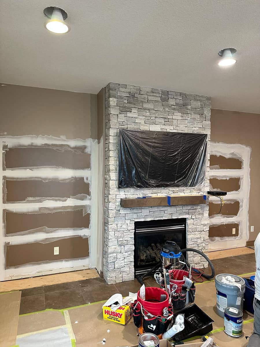 Bungalow Home Renovation — main-floor fireplace and floating shelves during finishing work