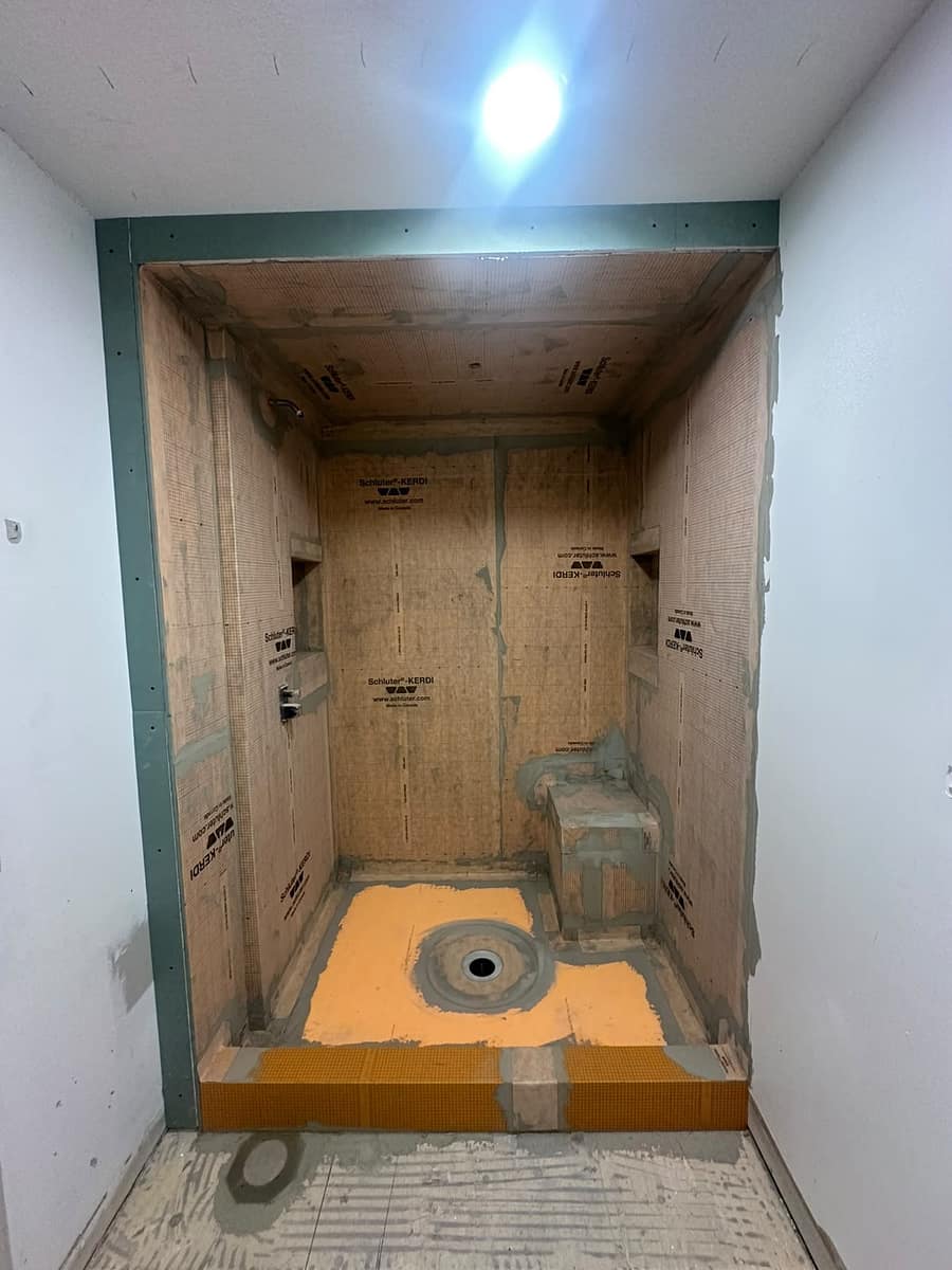 Chappelle Custom Bathroom Renovation — walk-in shower with Schluter-KERDI waterproofing membrane installed over backer board, bench and recessed niches