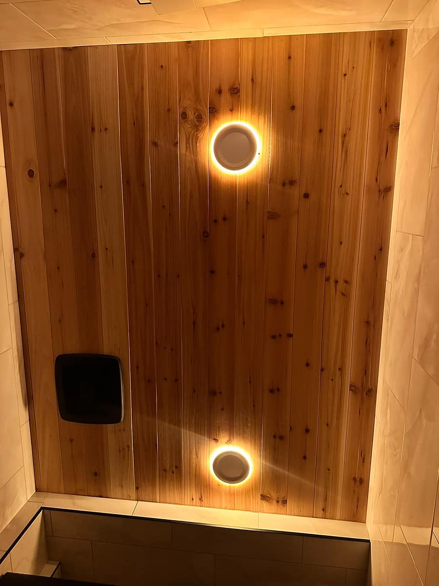 Chappelle Custom Bathroom Renovation — close-up of the stained tongue-and-groove wood ceiling with recessed lighting
