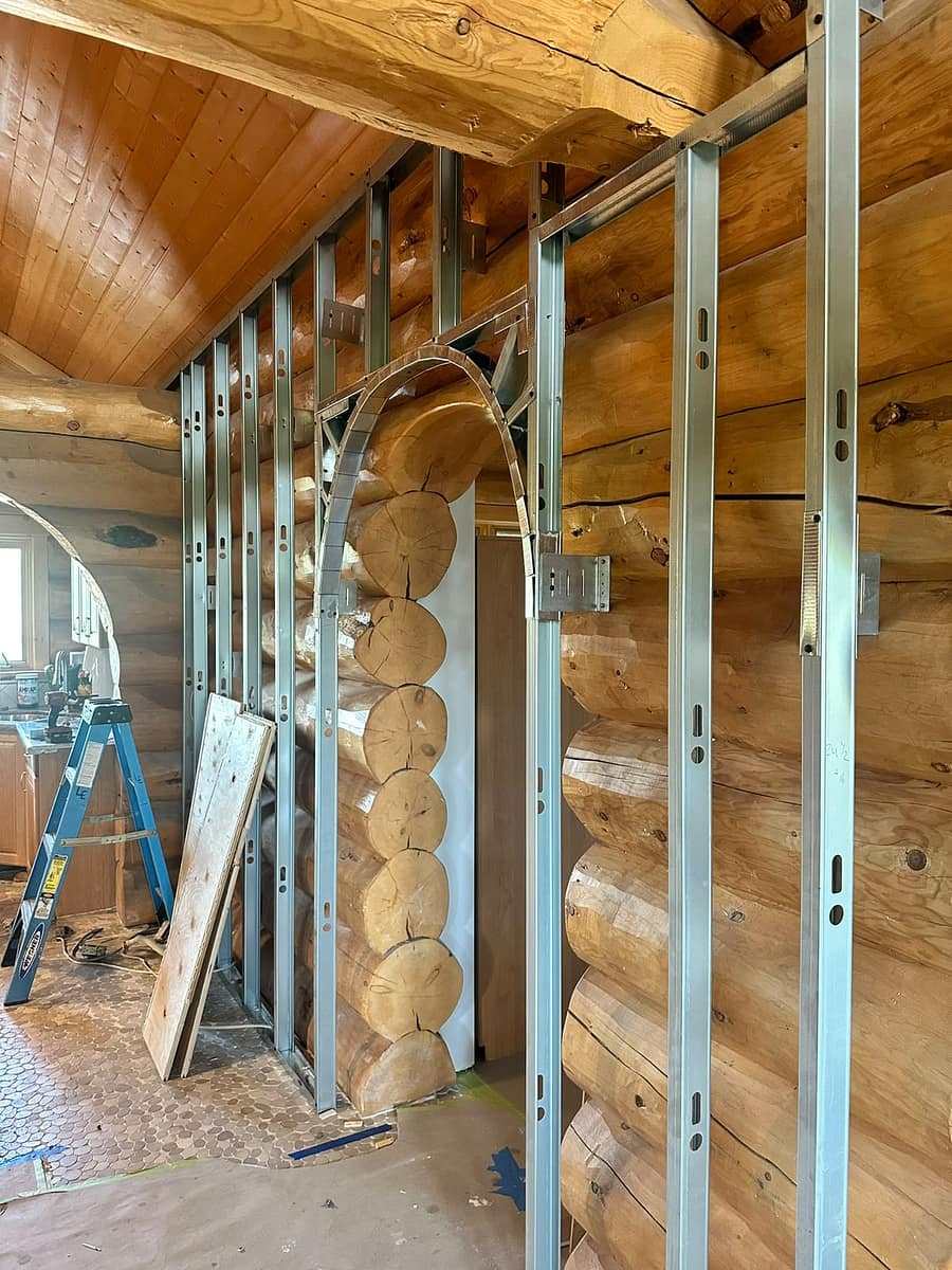 Custom Log Home Interior Renovation — side view of the arched opening construction and metal framing