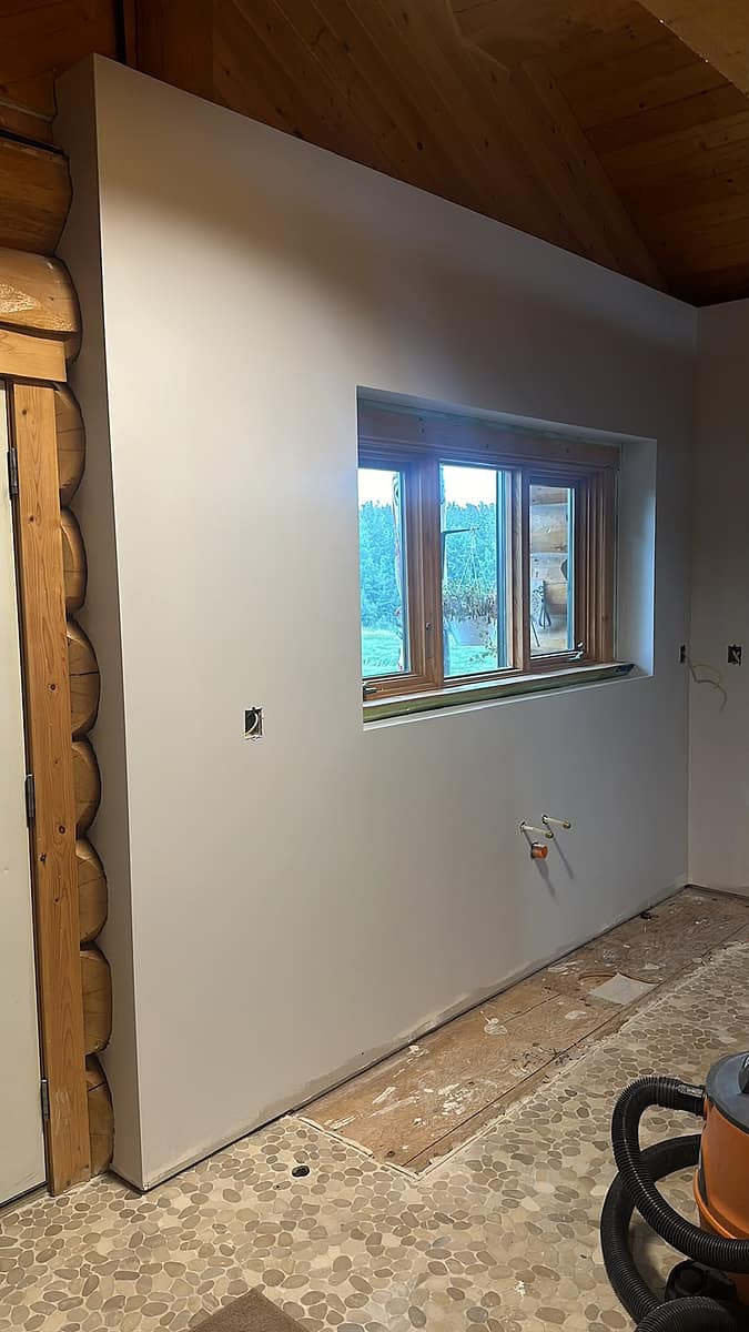 Custom Log Home Interior Renovation — finished wall built over the custom metal framing