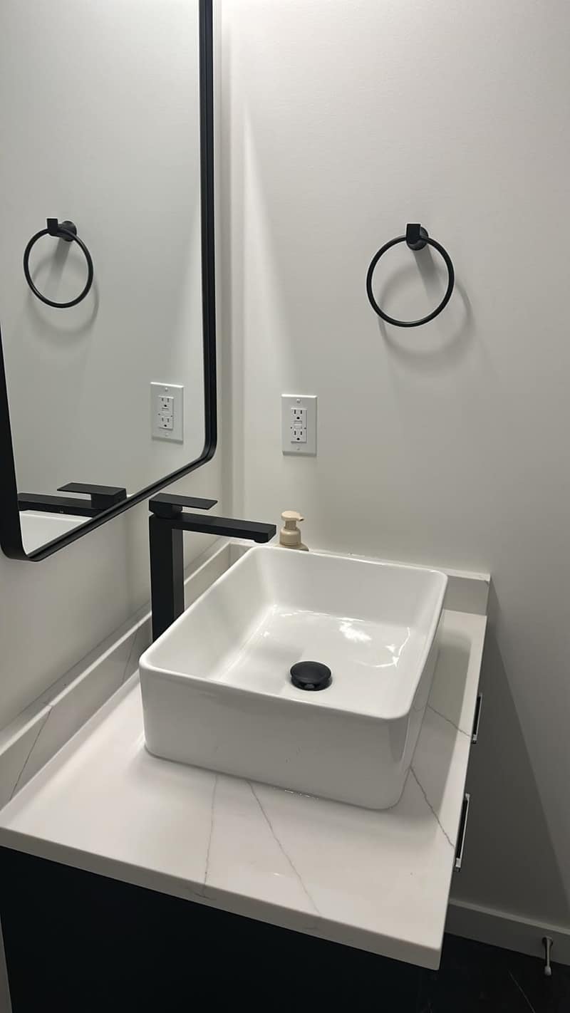 Basement Development — modern half bathroom with vessel sink and matte black fixtures