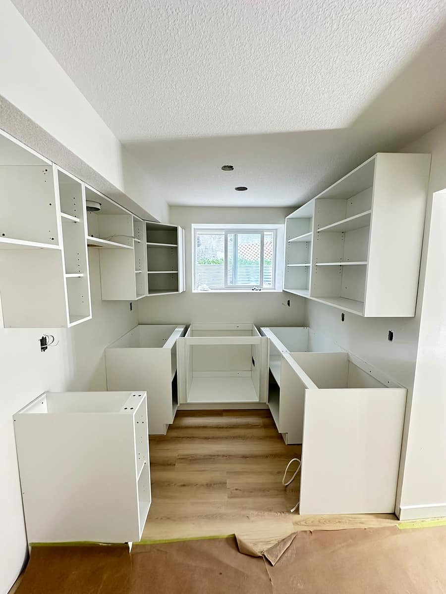 New white cabinetry installed during kitchen construction progress